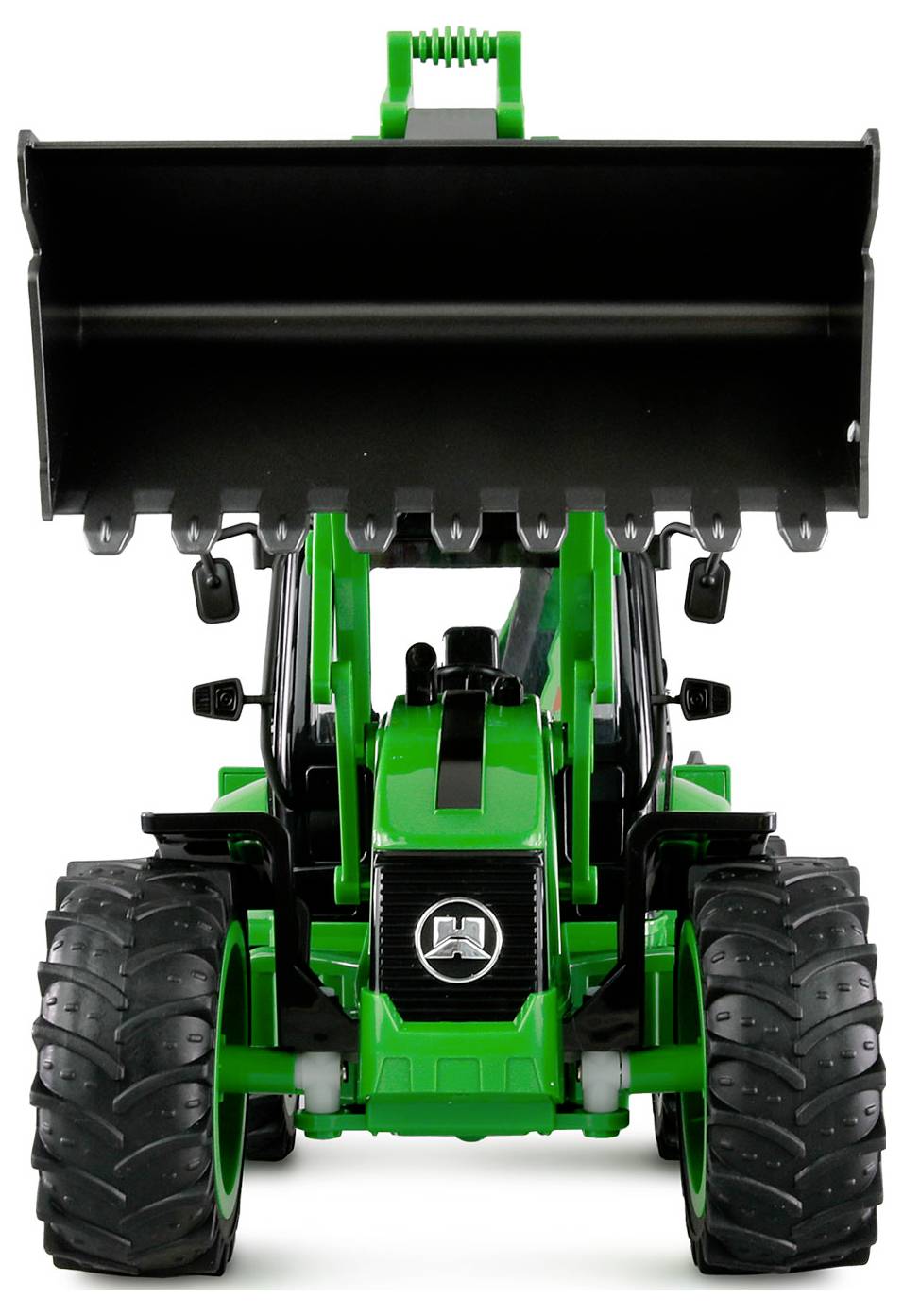 En grön traktor med en frontlastare, sedd framifrån, står stilla på en yta.