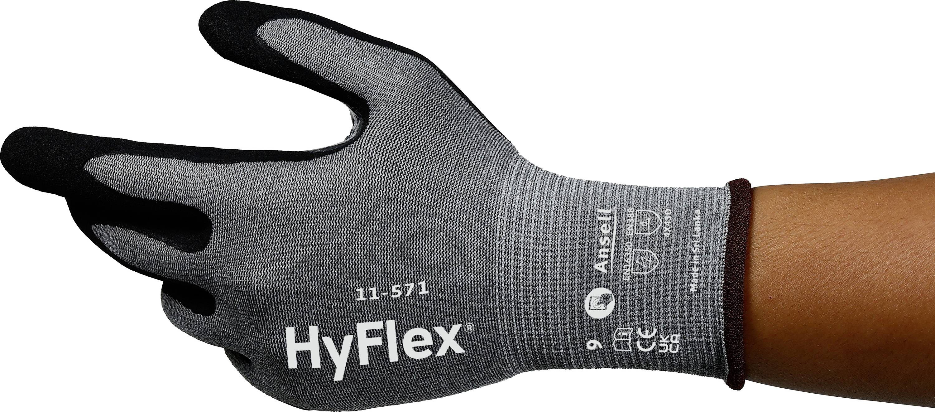 En vänster handske av grå tyg med svarta fingertoppar. Tryckt text 'HyFlex' och 'Ansell' med produktinformation.