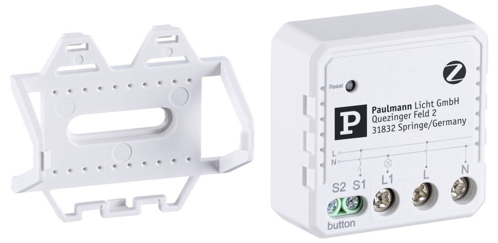 Liten, vit elektronisk enhet med anslutningar och företagstryck 'Paulmann Licht GmbH, Quezinger Feld 2, 31832 Springe/Germany'. Väggfäste till vänster bredvid.
