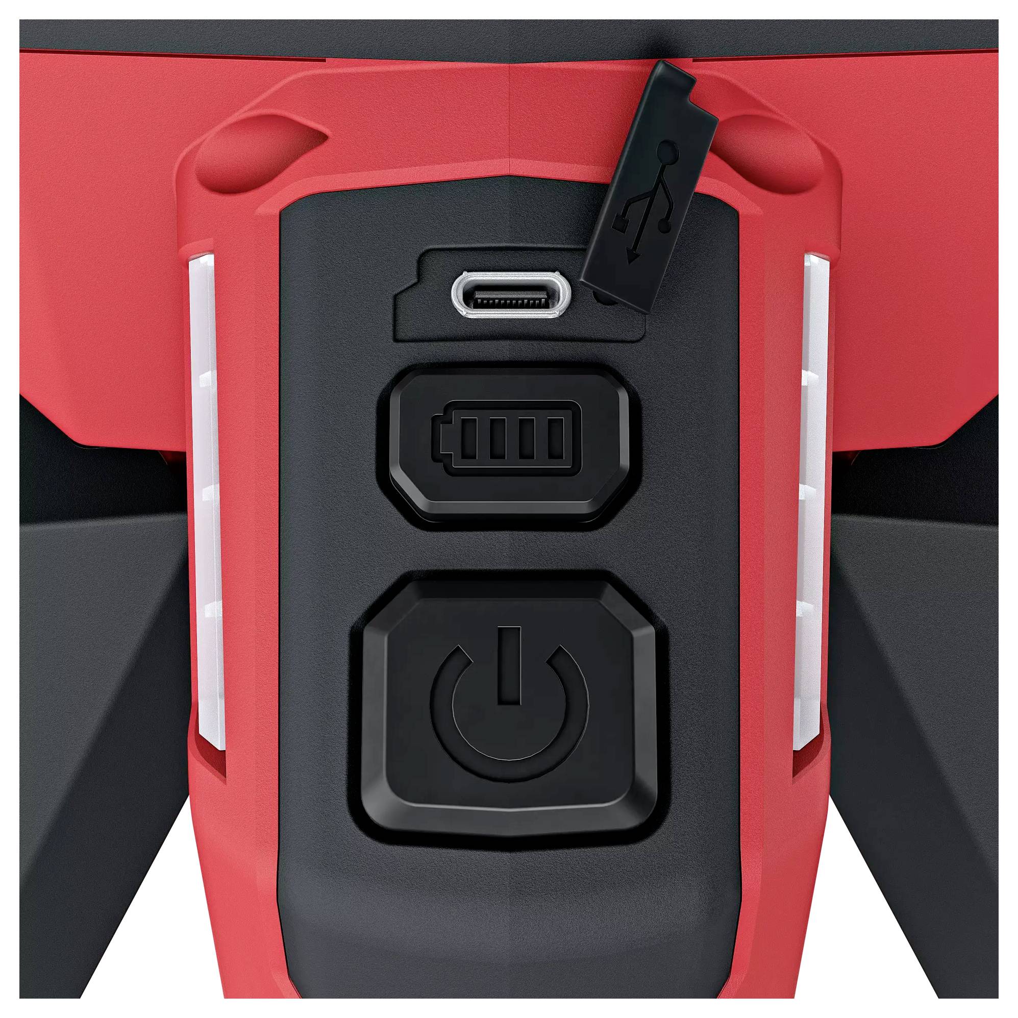 En närbild av en svart och röd enhet med en USB-port, ett batteristatus-indikator och en stor påslagningsknapp.