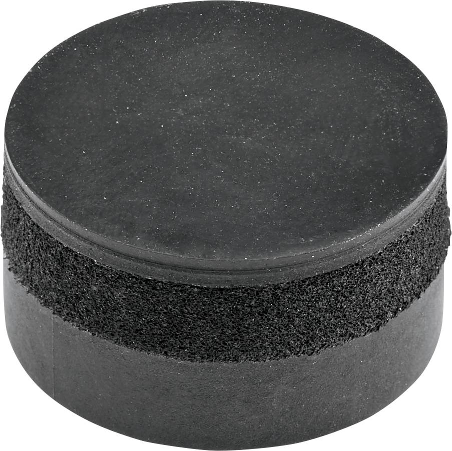 En svart ishockeypuck av gummi ligger på en yta.
