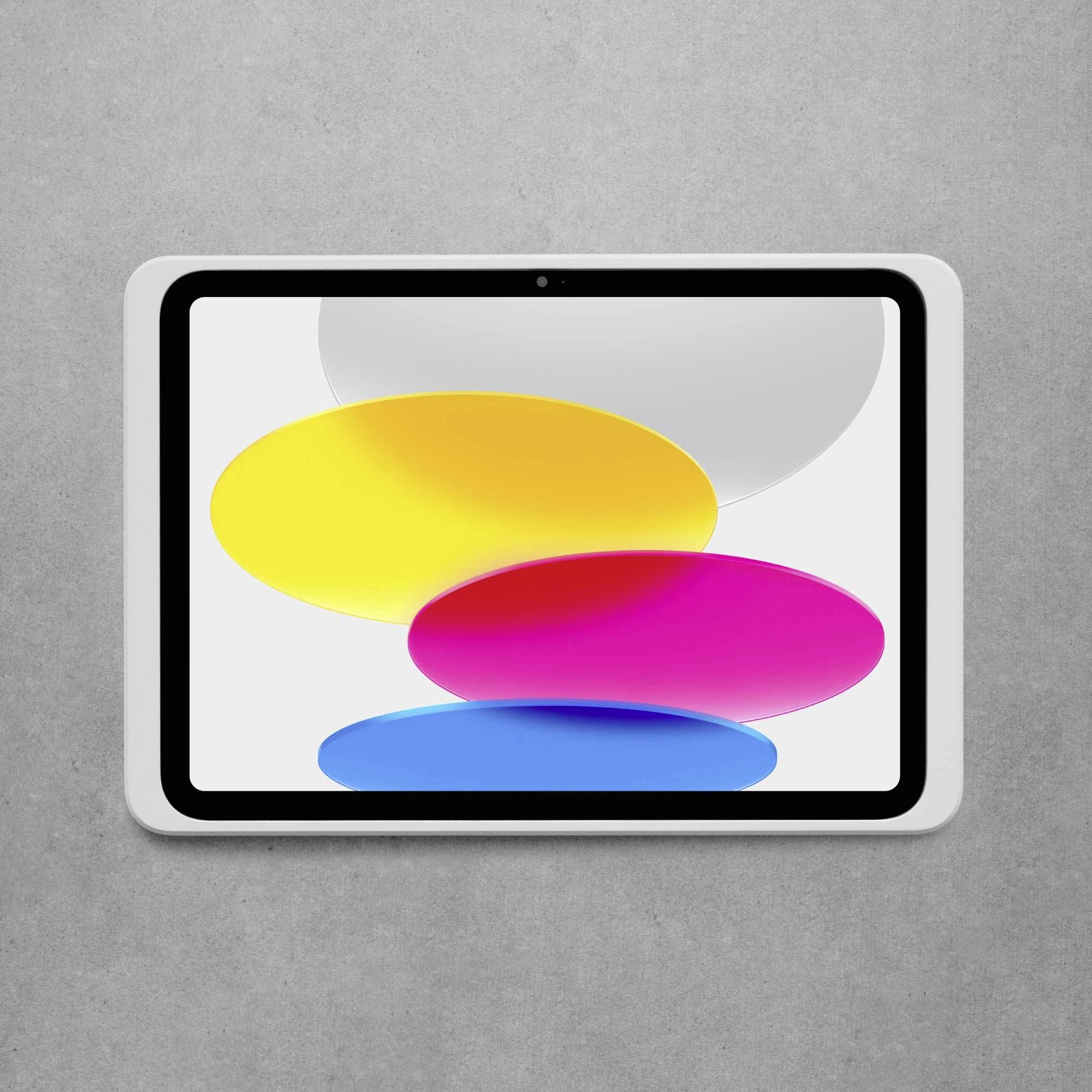 En surfplatta med färgglada ovala former på skärmen ligger på en grå yta.