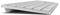En silver, trådlös tangentbord sett från sidan. Den är tunn och har en minimalistisk design.