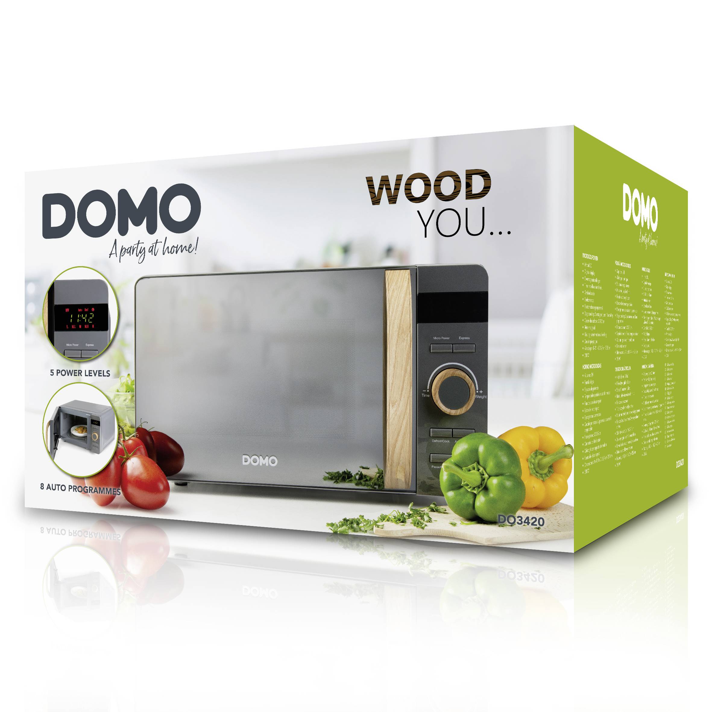 En mikrovågsugn från märket DOMO med trädetaljer på förpackningen. Text visar 'WOOD YOU...', '5 effektnivåer', '8 autprogram'. Olika paprika ligger bredvid.