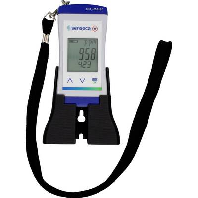 En bärbar CO₂-mätare med display visar '958 ppm'. Den har knappar för styrning och ett svart band att bära den med.