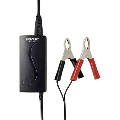 En svart batteriladdare märkt 'Voltcraft BC1200' med påsatta röda och svarta krokodilklämmor på trådar, vilket indikerar laddningsfunktionalitet.