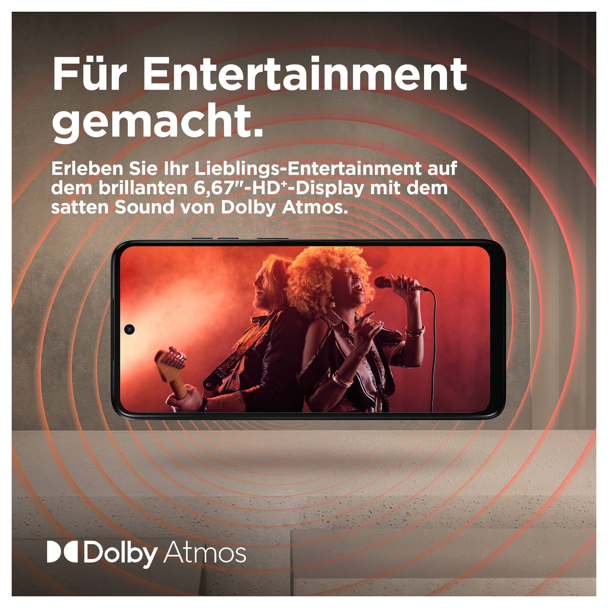 Handy med två personer som gör musik. Text överst: "Gjord för underhållning." Nederst: "Dolby Atmos"-logotyp.