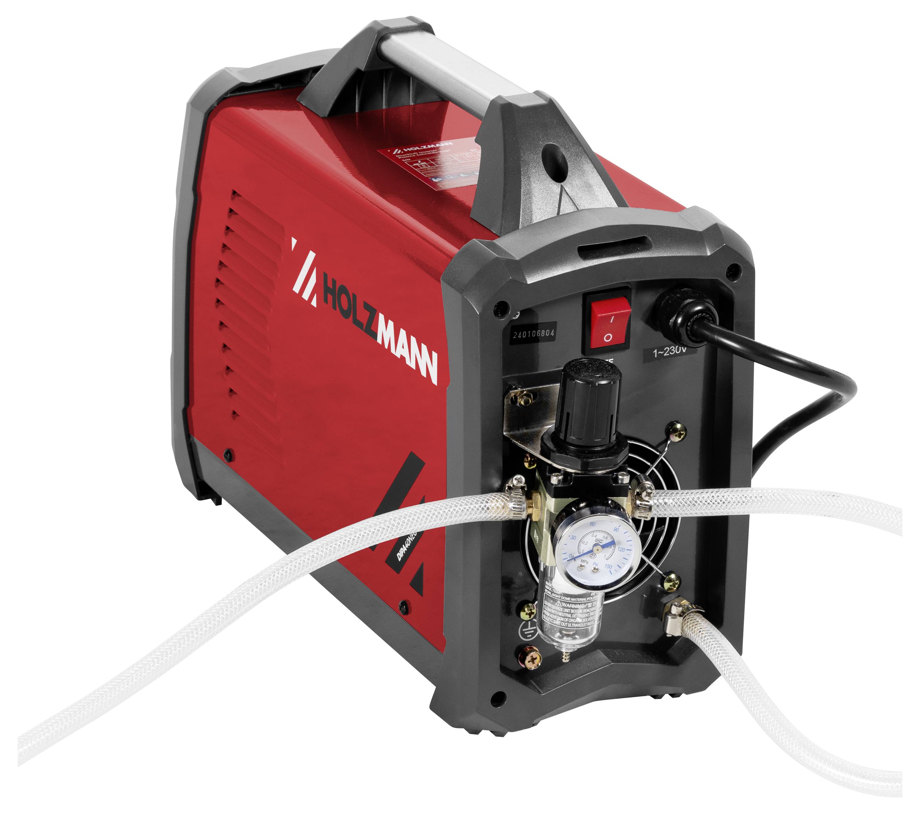 En röd och grå industriell svetsmaskin med mätare, rattar och slangar anslutna, använd för metallbearbetning.