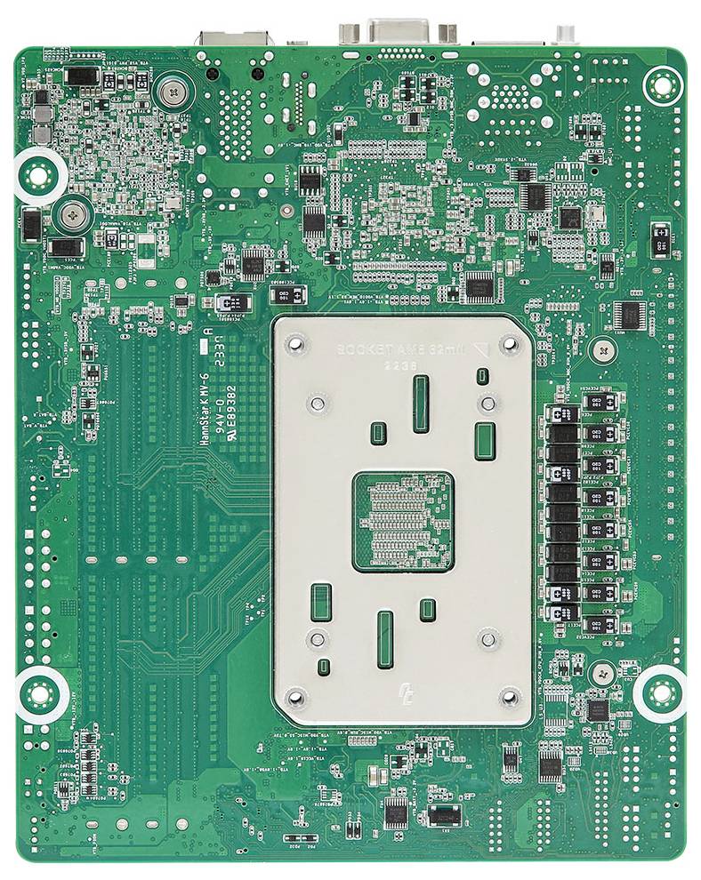 En grön kretskort med olika elektroniska komponenter, inklusive en central metallplatta, kontakter samt små resistorer och kondensatorer.