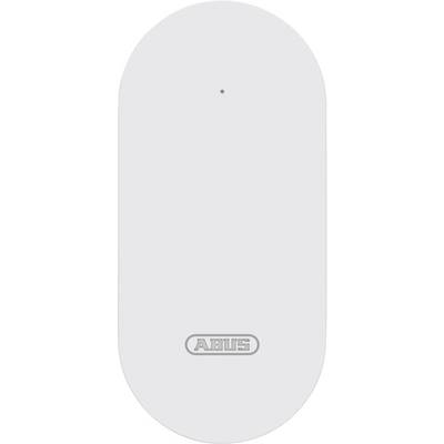 En vit rektangulär sensorenhet med en liten prick längst upp och varumärkets logotyp 'ABUS' längst ner i mitten.