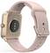 En roséguldfärgad smartwatch med ett rosa band, som visar dess baksida och sensorer.