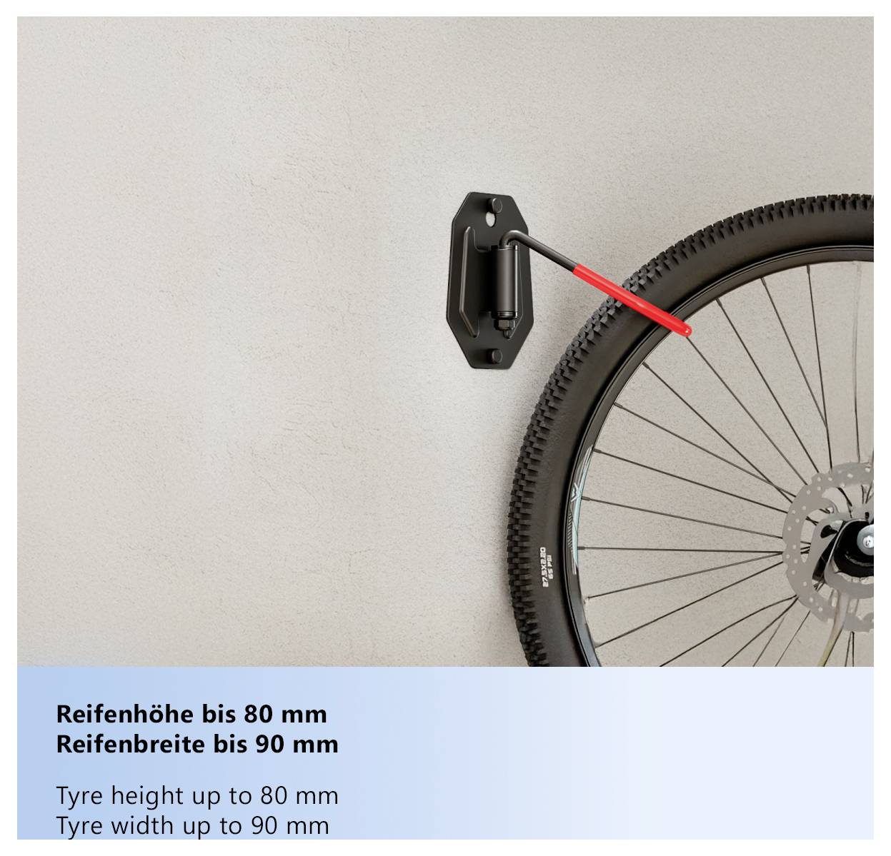 Cykelhjul monterat på en väggkrok. Text nedan lyder "Reifenhöhe bis 80 mm, Reifenbreite bis 90 mm, Däckhöjd upp till 80 mm, Däckbredd upp till 90 mm".