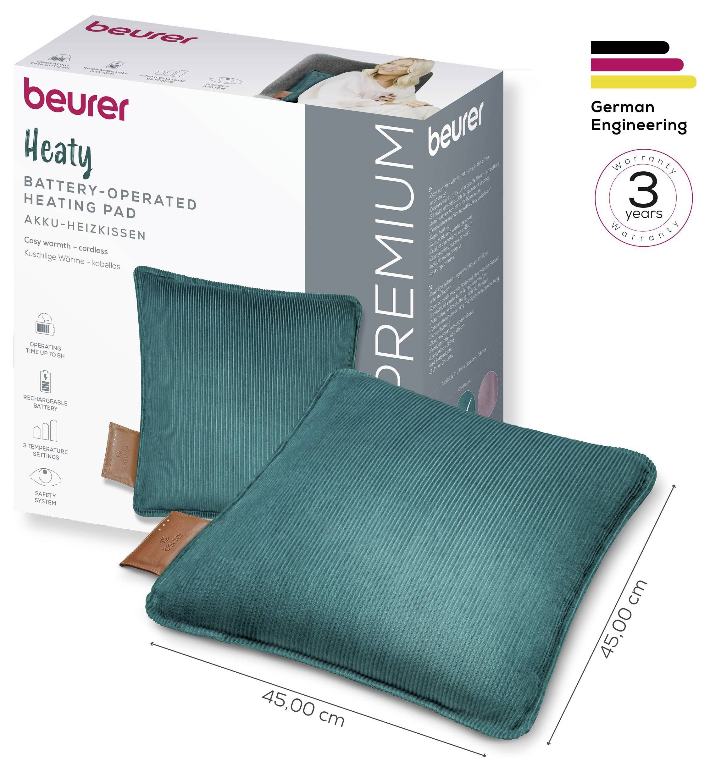 'Beurer batteridriven värmekudde, teal-färgat tyg, 45x45 cm, visas bredvid produktförpackningen. Framhäver 3 års garanti och tysk ingenjörskonst.'