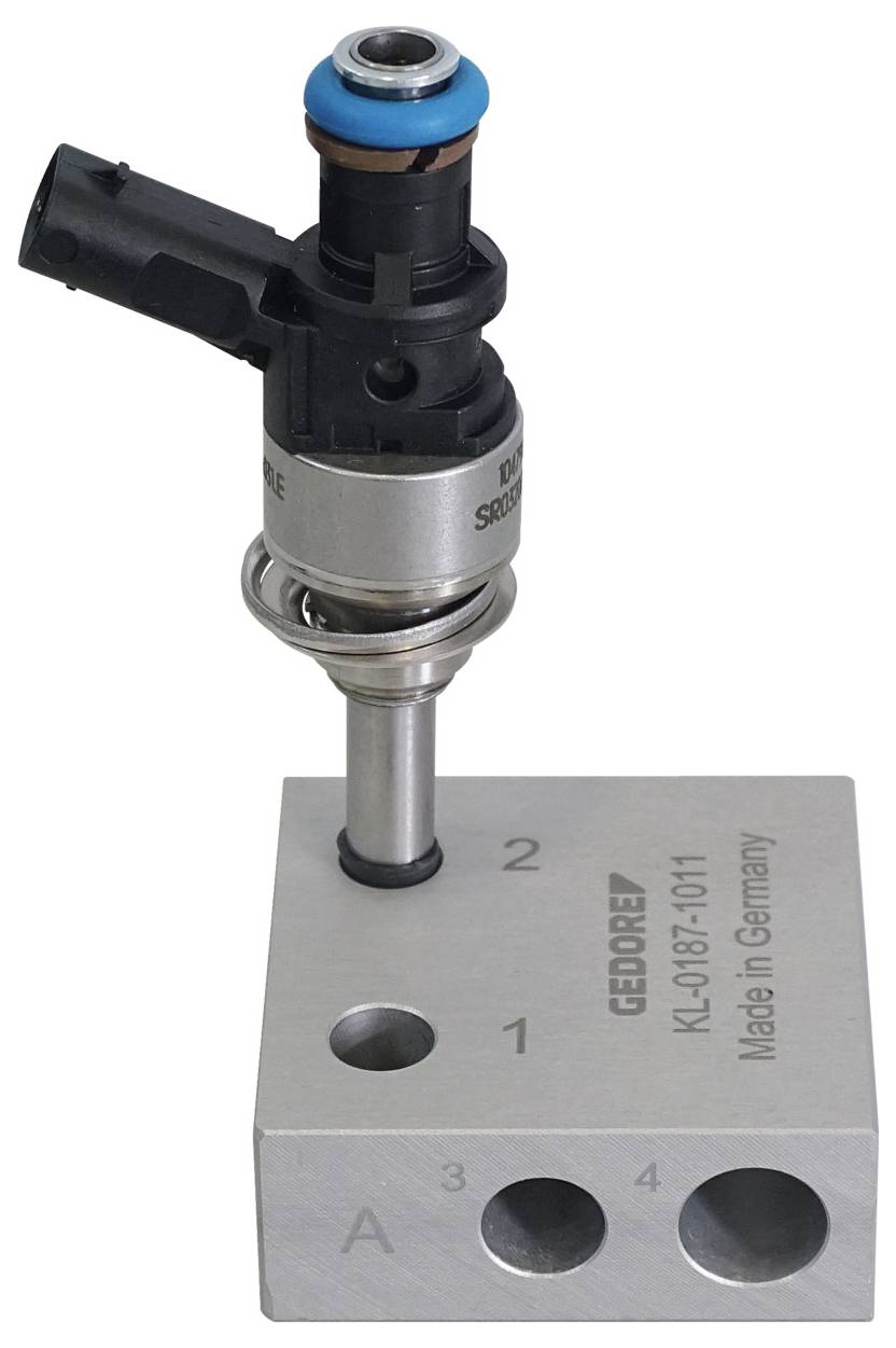 En mekanisk sensor eller insprutare är monterad på ett metallblock märkt "Gedore KL-0187-1011 Made in Germany," med numrerade portar.
