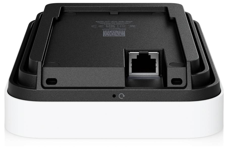 'Bakvy av en svart och vit elektronisk enhet med en Ethernet-port och strömknapp, utformad för anslutnings- eller laddningsändamål.'