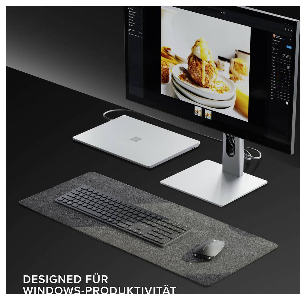 Arbetsutrymme med bildskärm, tangentbord, mus och Surface-tillbehör; skärmen visar fotobehandling, med text "DESIGNAD FÖR WINDOWS-PRODUKTIVITET" som indikerar Windows-produktivitet.