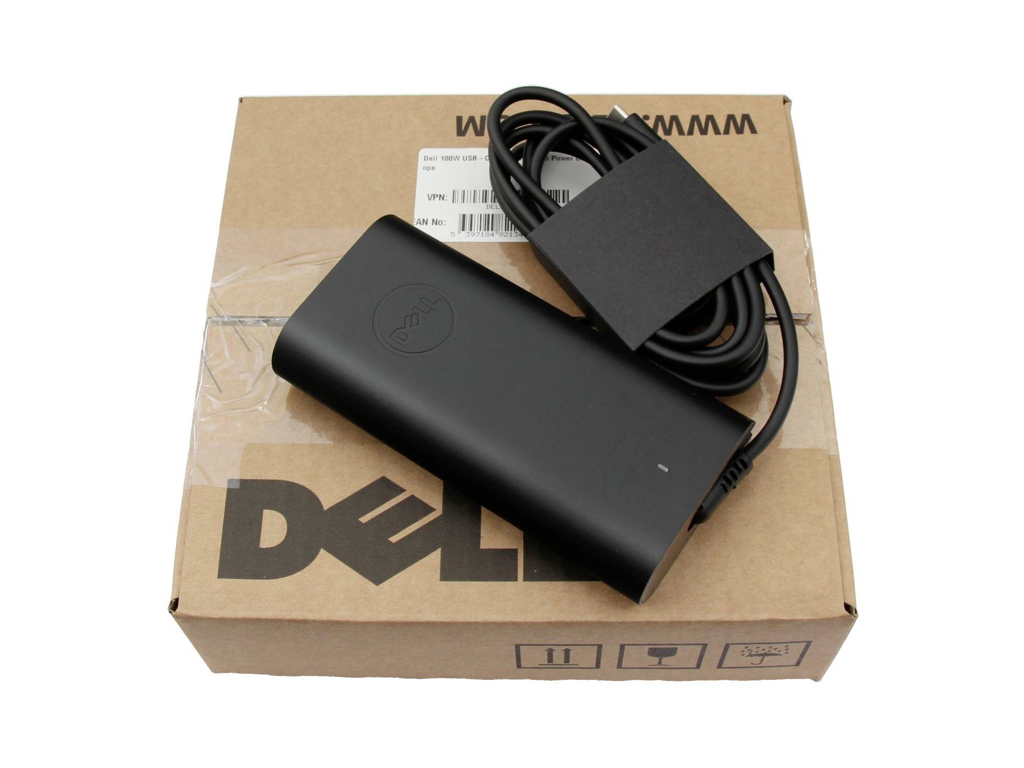 Dell-strömadapter för bärbar dator med spiralvindat kabel vilande på en Dell-kartongkartong