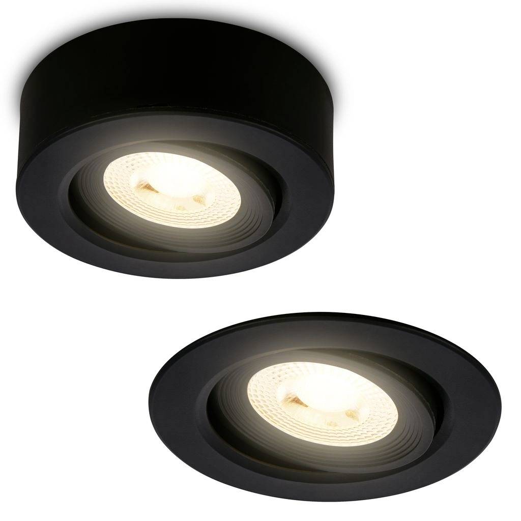 Två svarta inbyggda takspotlights med upplysta LED-lampor, visade mot en vit bakgrund.