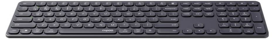 Fullstorlek svart trådlöst tangentbord med numerisk knappsats och låga tangenter visat på vit bakgrund.