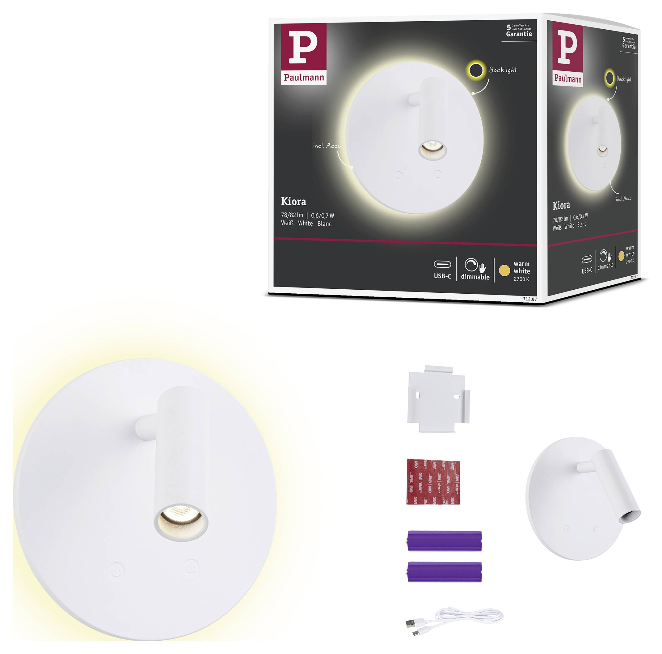 Produktbild av en vit Paulmann Kiora LED-vägglampa med varm bakbelysning, visad tillsammans med sin förpackning och medföljande monteringstillbehör.