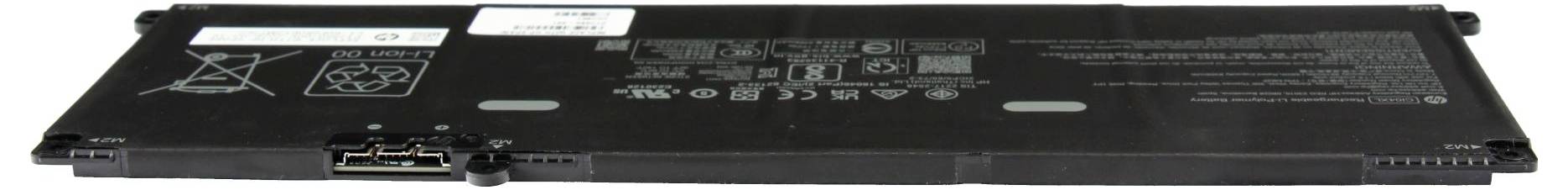 Långt svart laptopbatteriladdningspaket visat från undersidan, med etiketter, varningsikoner och kontaktkontakter på ena änden.