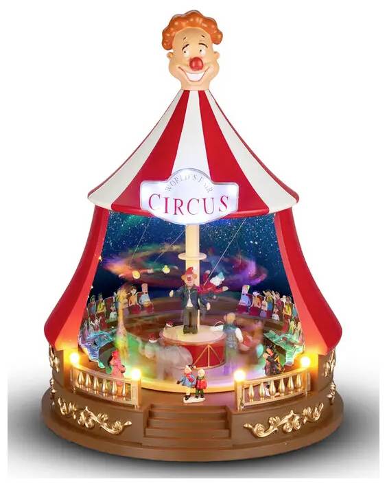 Miniatyrskåp av cirkustält med clowntoppsats, upplyst scen och "CIRCUS"-skylt, som visar artister och publik inuti.
