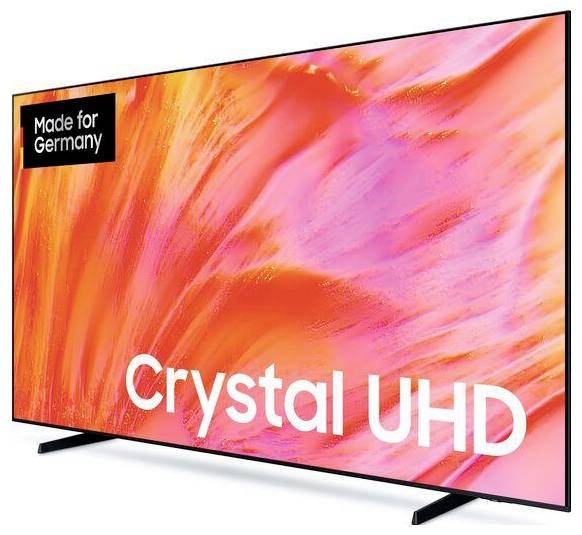 Platt-TV som visar levande rosa-orange abstrakt konst, märkt "Crystal UHD" med en "Tillverkad för Tyskland"-märkning.