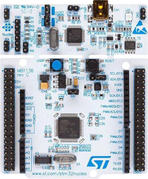 Mikrocontrollerkort med talrika anslutningar och komponenter. Central chip, LED-indikatorer och USB-port för utvecklingsändamål.