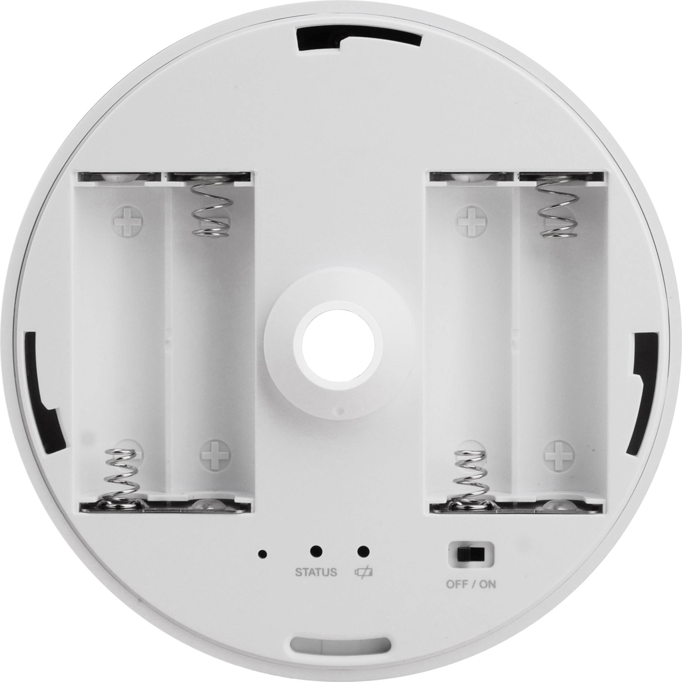 Baksidan av en rund enhet med två batterifack, en statuslampa och en på/av-knapp.