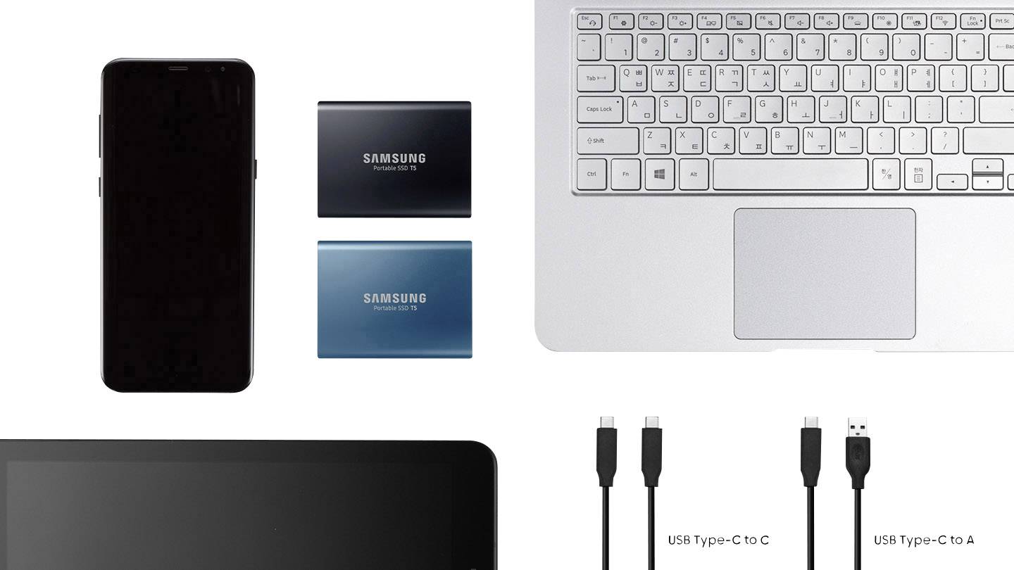 Smartphone, två externa hårddiskar, laptoptangentbord och USB-kabel. Teknologiska enheter i en översikt ovanifrån.