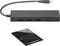 En svart USB-hubb med tre USB-portar, ansluten via en kort kabel. Bredvid ligger en produktbeskrivning.
