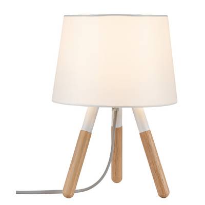 Vit bordslampa med trebent träfot och tygskärm, tänd.