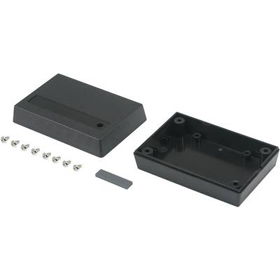 Svart elektronikkapsel med borttagen lock, sju skruvar och en extra liten grå komponent på vit bakgrund.