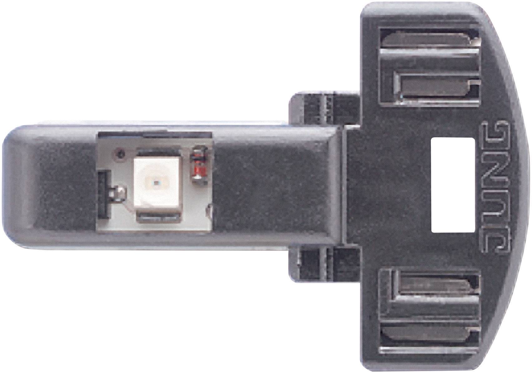 En svart plastdetalj med en inbyggd elektronisk komponent, möjligen en sensor eller en LED, märkt med 'JUNG'.