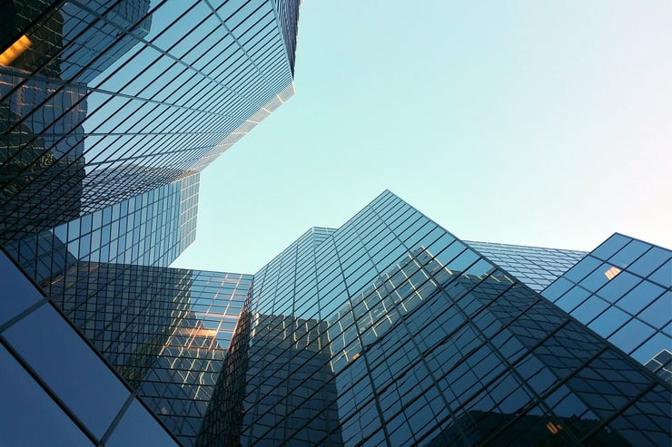 Moderne Bürogebäude mit Glasfassade vor klarem Himmel