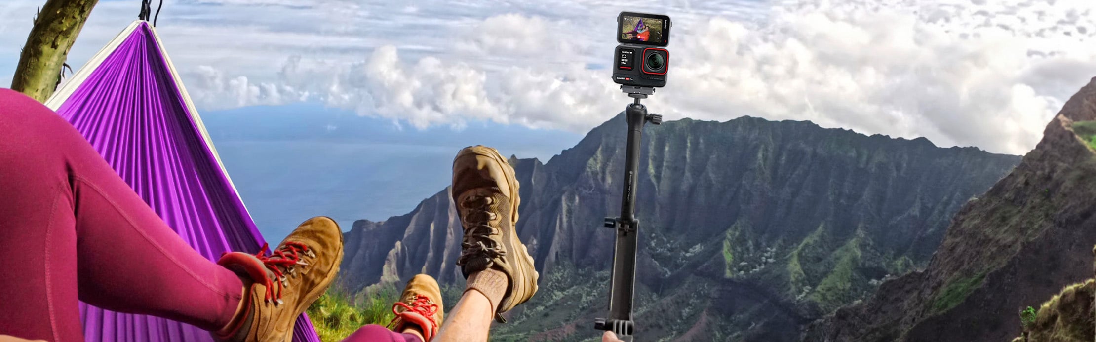 Person entspannt in einer Hängematte mit Blick auf eine Berglandschaft, während eine Action-Kamera auf einem Stativ daneben steht.