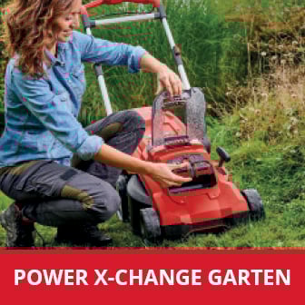  Eine lächelnde Frau in Jeanshemd und Arbeitshose setzt einen Akku in einen roten Rasenmäher der Marke Einhell, mit der Aufschrift "POWER X-CHANGE GARTEN" am unteren Bildrand, ein, während sie auf einer grünen Wiese kniet.
