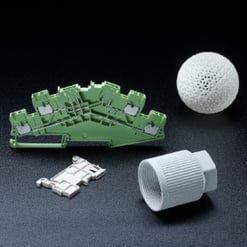 weiße poröse Kugel, ein silbernes Metallteil und ein geriffeltes weißes Kunststoffteil.