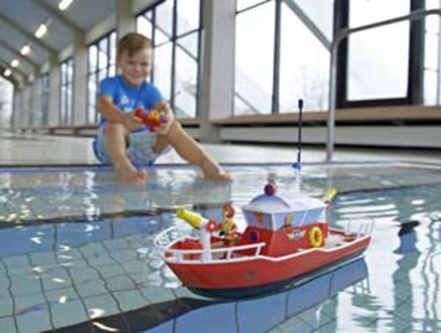 Child plays with fire-fighting boat