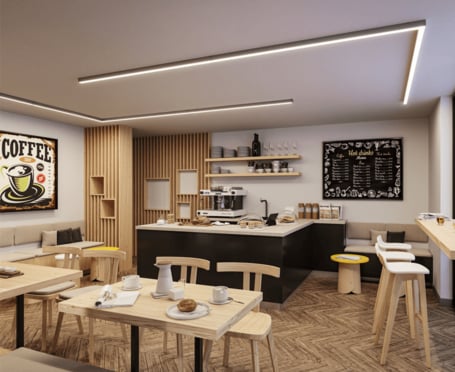 Anwendungsbeispiel 3: Dieses Bild zeigt das Innere eines gemütlichen und modernen Cafés. Das Lichtsystem ist in zwei rechtwinkig angeordneten Elemente an der Decke montiert und prägt zum zeitgenössischen Flair des Raumes. Insgesamt ein stilvolles Ambiente, das darauf abzielt, einen Ort zum Entspannen und Kaffeegenuss zu schaffen.
