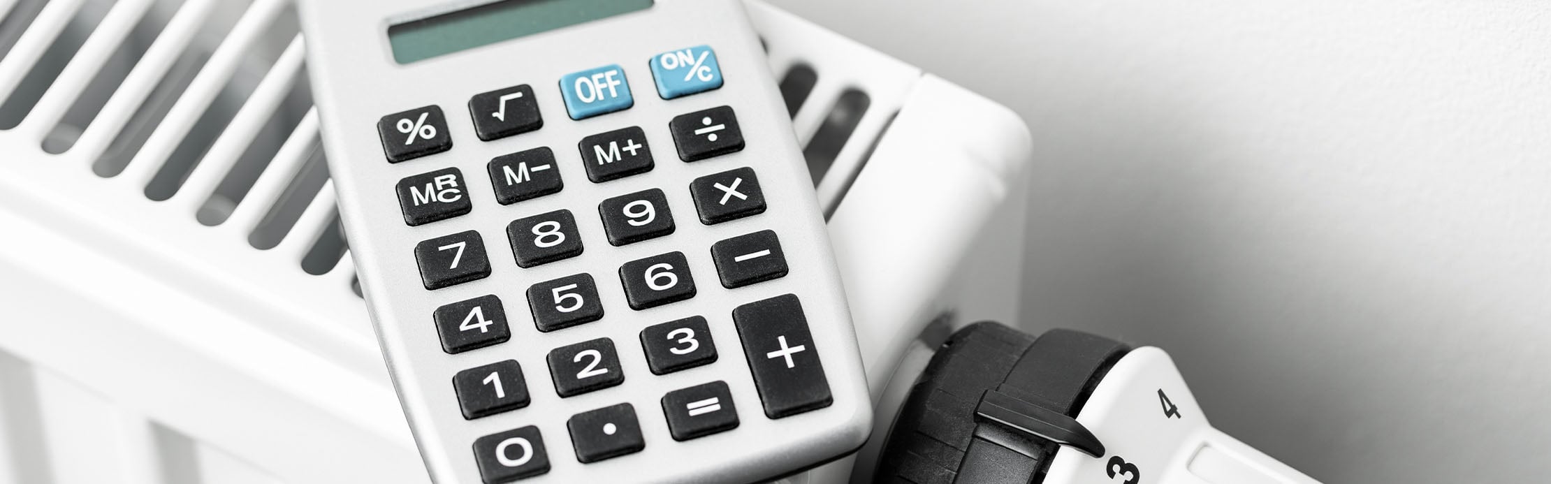 Une calculatrice grise est posée sur un radiateur
