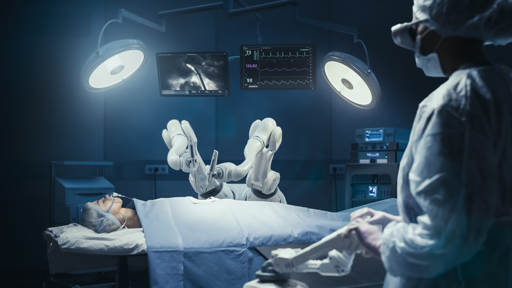 Salle d'opération équipée d'un robot chirurgical qui traite un patient tandis que le personnel médical supervise le dispositif